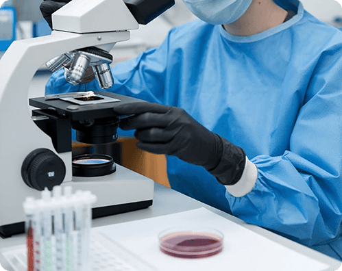 Laboratory professional examining a sample under a microscope